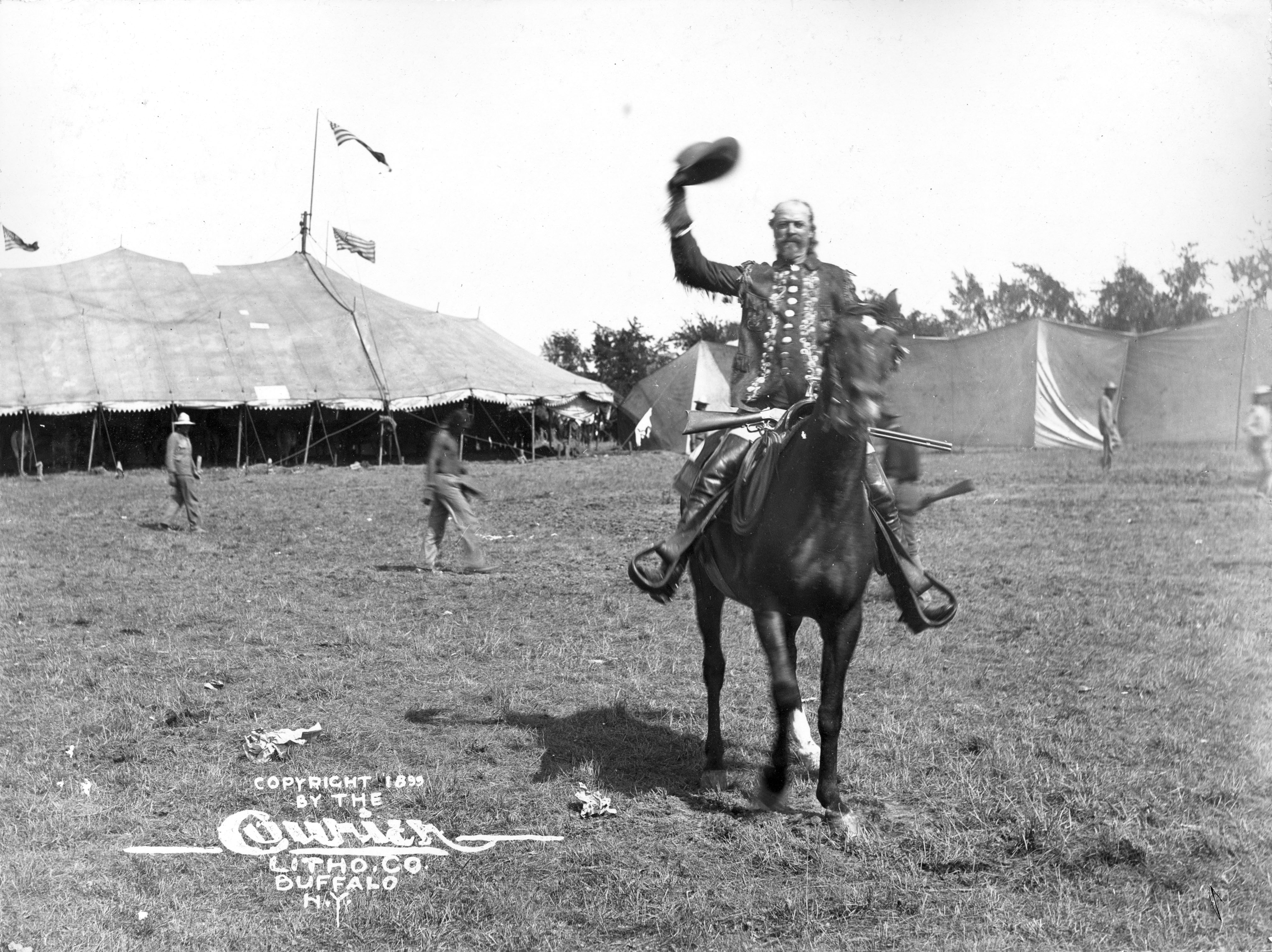 Buffalo Bill waves his hat while on horseback, 1899 [NS-543, Courtesy Denver Public Library Western History Department]